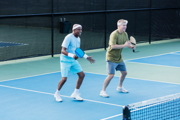 Two male pickleball teammates involved in a match