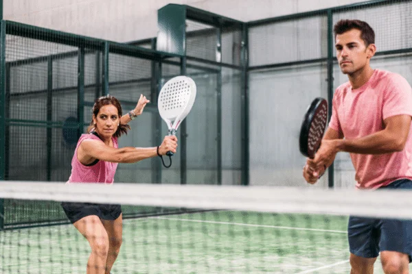 A mixed padel team playing on the court